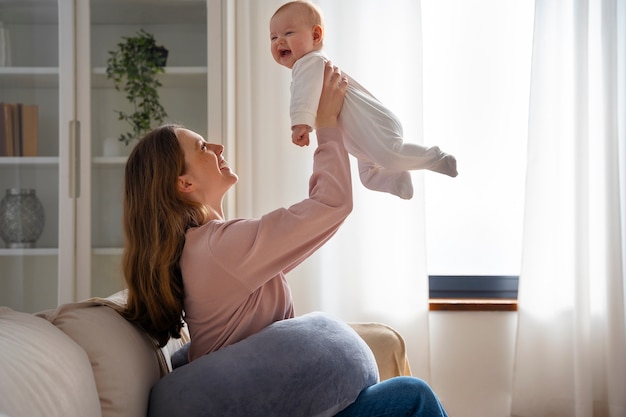 Side view mother with cute newborn