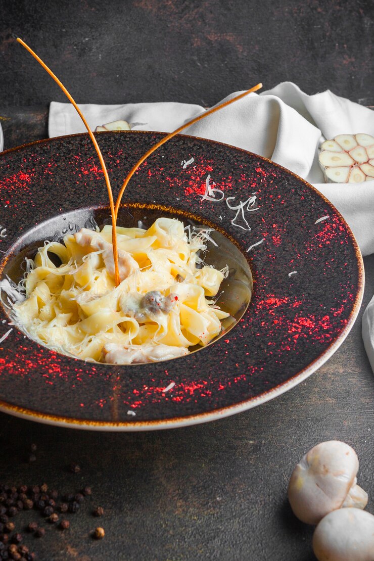Free Photo side view mushroom pasta with champignon in round plate