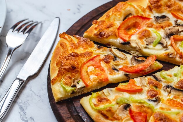 Side view mushroom pizza with tomato bell pepper cheese and mushrooms