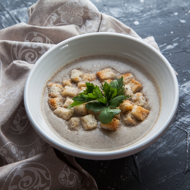 Side view mushroom soup with crackers and napkins