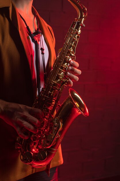 Side view of musician playing the saxophone