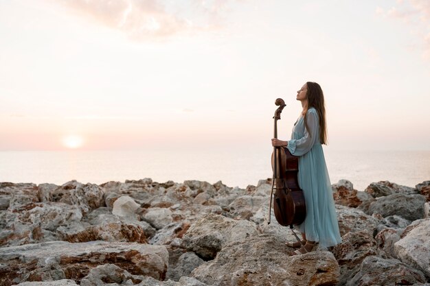 Side view of musician with cello