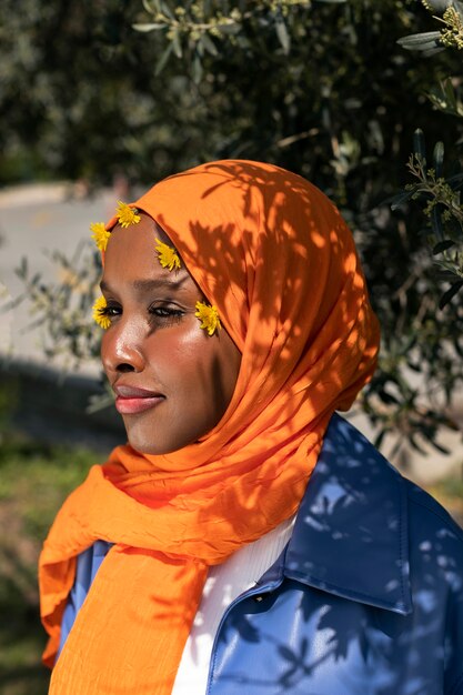 Side view muslim woman posing outdoors