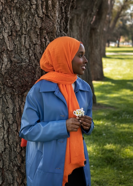 Free photo side view muslim woman posing outdoors