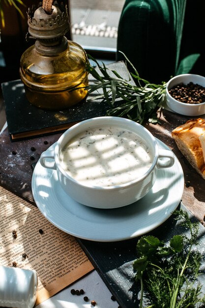 Side view of a national azerbaijani food dovga in a white bowl