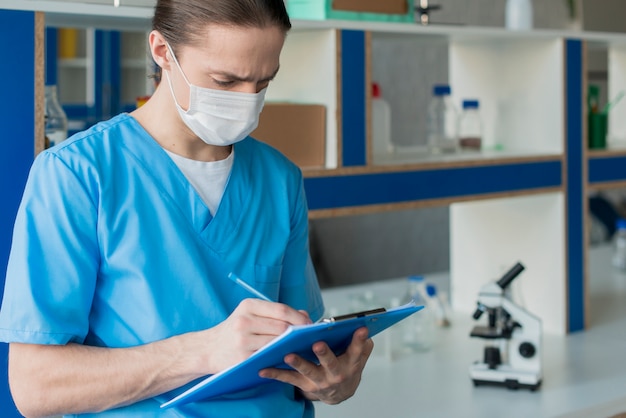 Side view nurse with clipboard