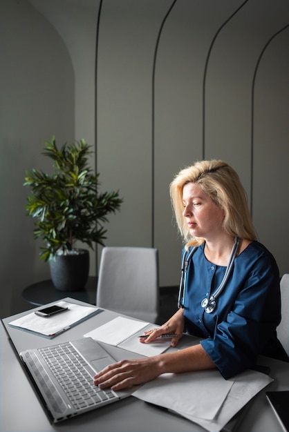 Side view nurse working at desk