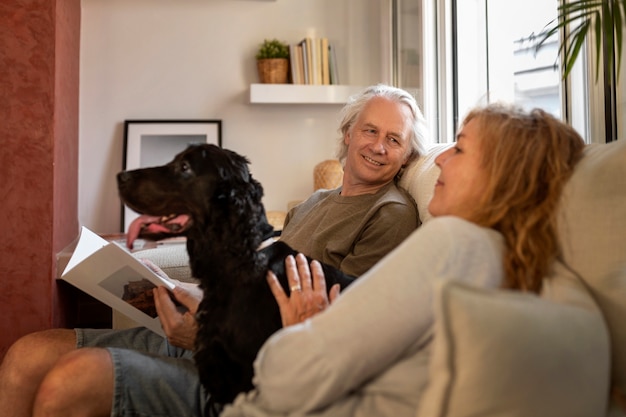 Side view old couple petting dog