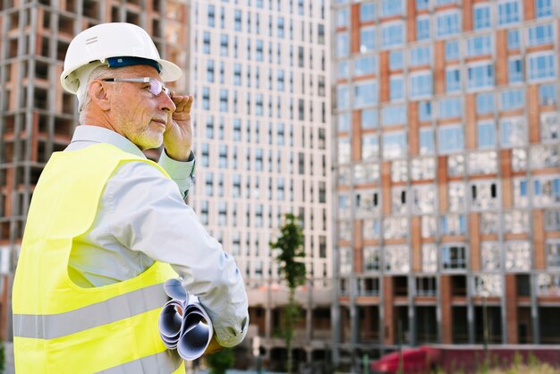 Side view old man with glasses and helmet