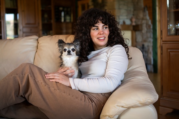 Side view owner sitting on couch with dog