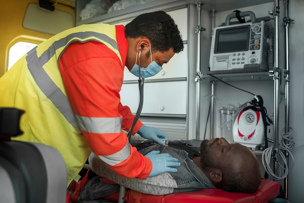 Side view paramedic checking victim