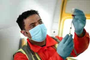 Free photo side view paramedic holding injection