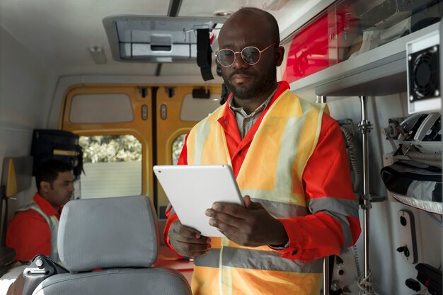 Side view paramedic holding tablet