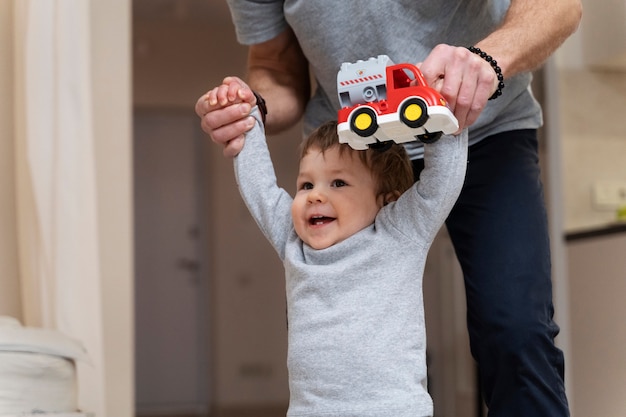 Side view parent holding kid's hands