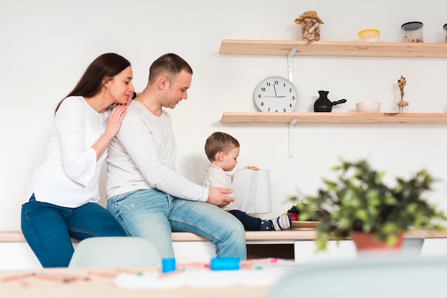 Side view of parents with child in the kitchen