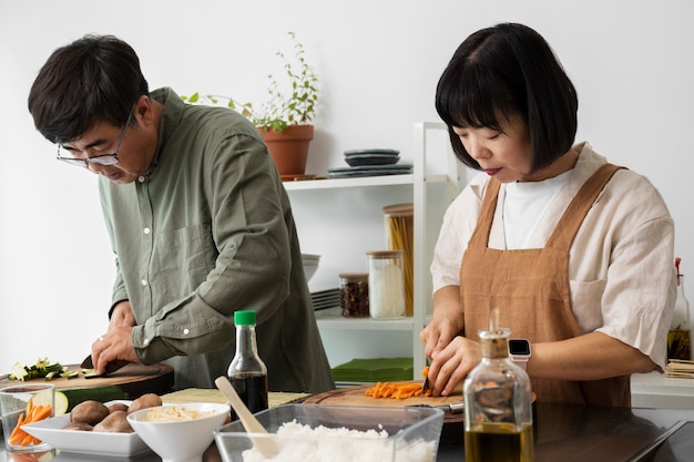 Free photo side view partners cooking together