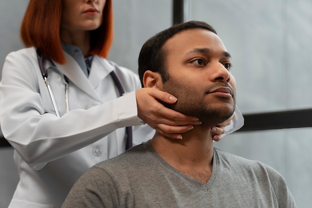 Free photo side view patient undergoing physical evaluation