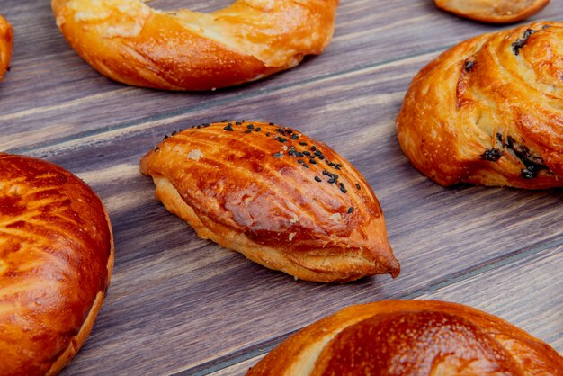 Side view of pattern of different bakery products on wooden surface