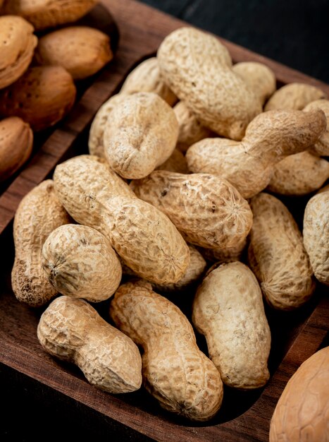 Side view of peanuts in shell on a wooden tray