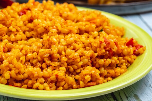 Side view pearl barley fried pearl barley with chopped tomato on a plate