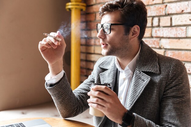 Side view of pensive businessman in eyeglasses