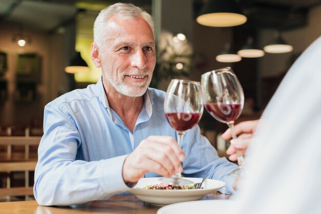 Side view people clinking glasses at restaurant