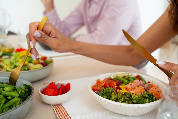 Side view people eating salmon bowls