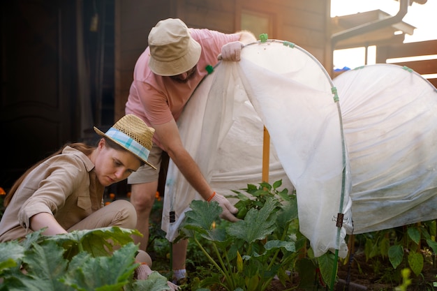 Free photo side view people gardening together