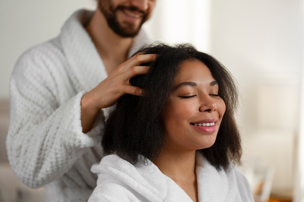 Side view people giving themselves scalp massage