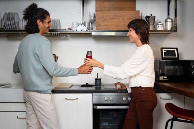 Free photo side view people holding flask