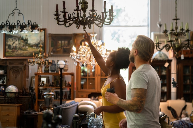 Side view people looking at chandelier