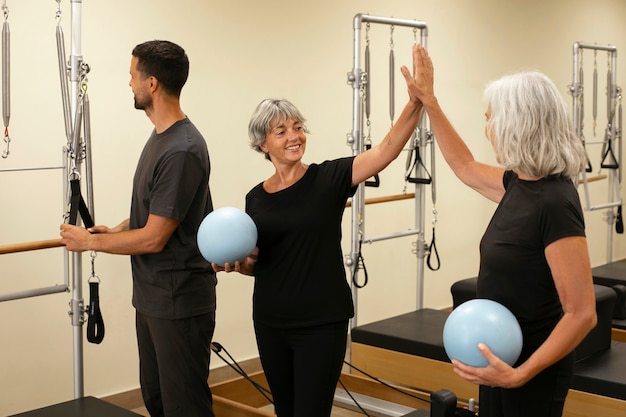 side-view-people-pilates-class_23-2150778125.jpg