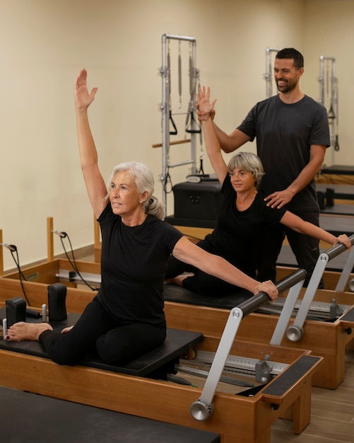 Side view people in pilates class