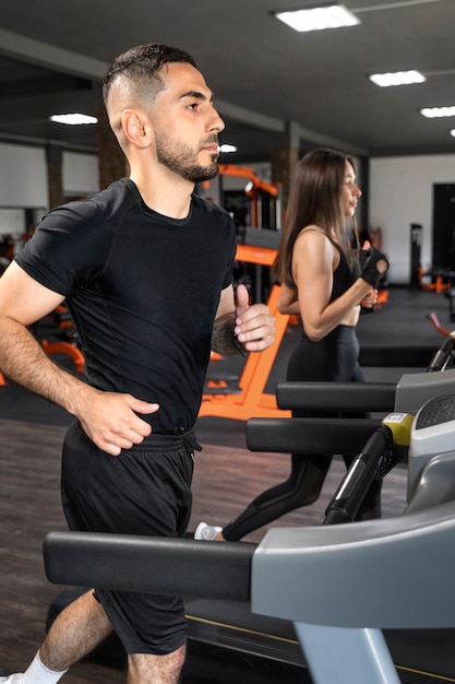 Side view people running on treadmill