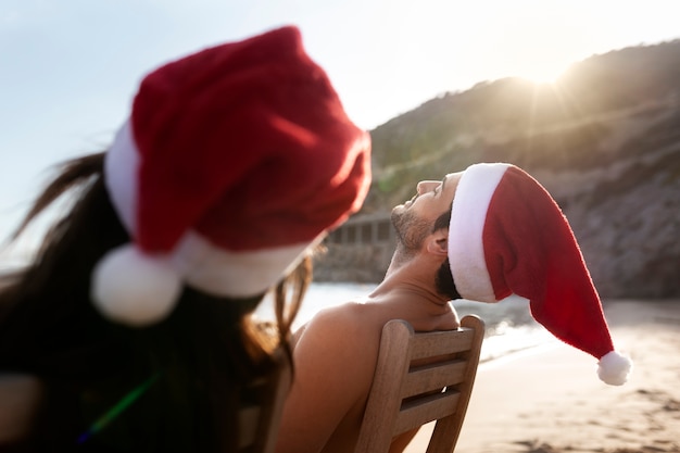 Side view people wearing santa hats