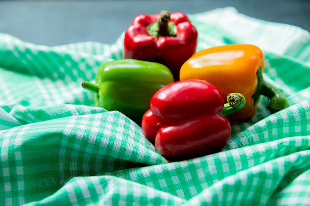 Side view of peppers on cloth surface