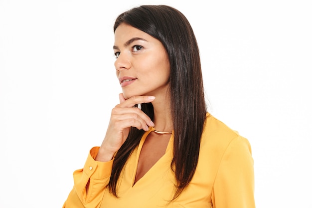 Side view photo of thinking beautiful brunette woman touching her chin