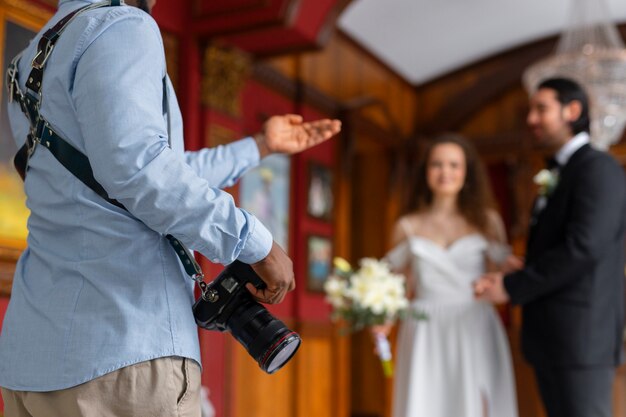 Side view photographer and married couple