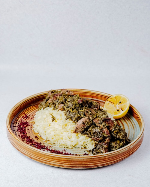 Side view of pilaf with stewed meat herbs and spices