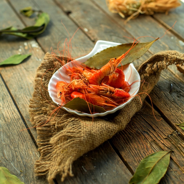 Side view of a plate with boiled shrimps