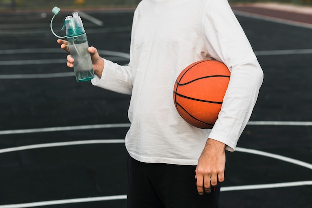 Side view player holding basketball