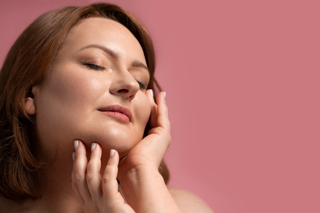 Side view plus size model posing in studio