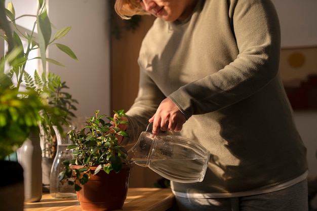 Free photo side view plus-sized man taking care of plants