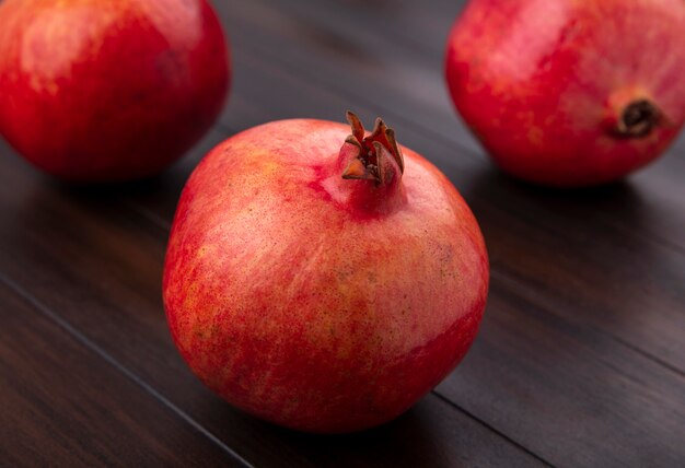 Side view of pomegranate on a wooden surface