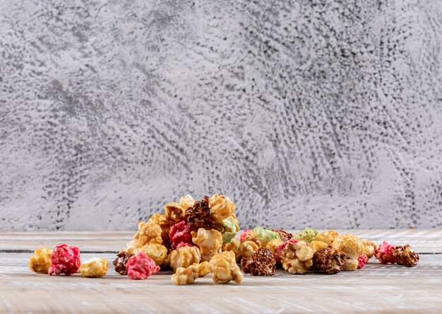 Side view of popcorn on white wooden table horizontal