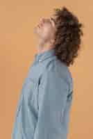 Free photo side view portrait curly haired young man