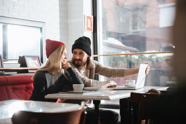 Side view of pretty couple with laptop