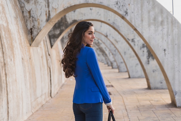 Side view of pretty girl with blue jacket