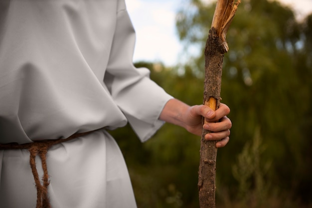 Free photo side view prophet holding stick