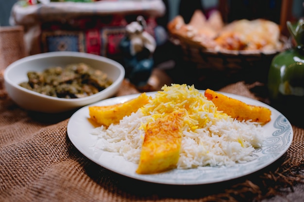 Side view of pumpkin with rice on a white plate